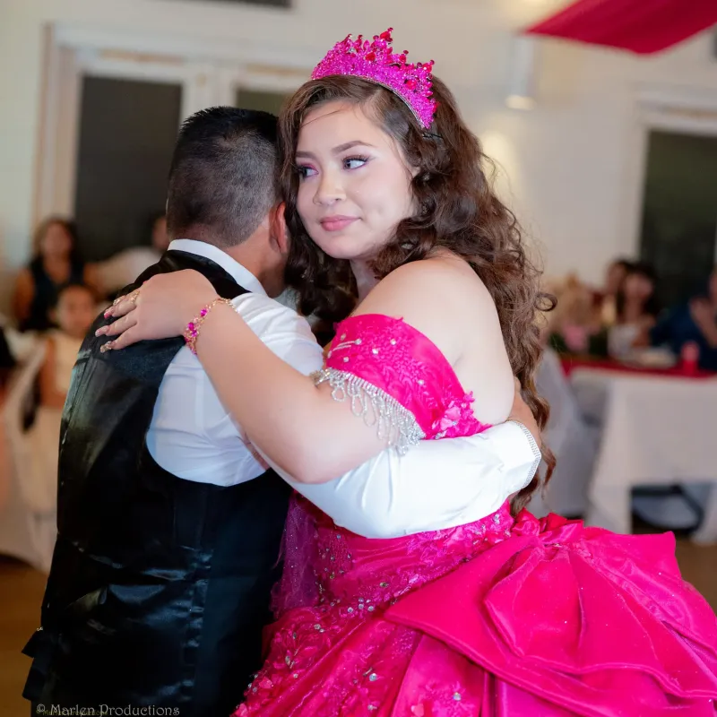 Father and daughter dance during a quinceanera celebration