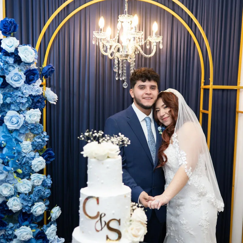 Wedding couple celebrating beside their cake