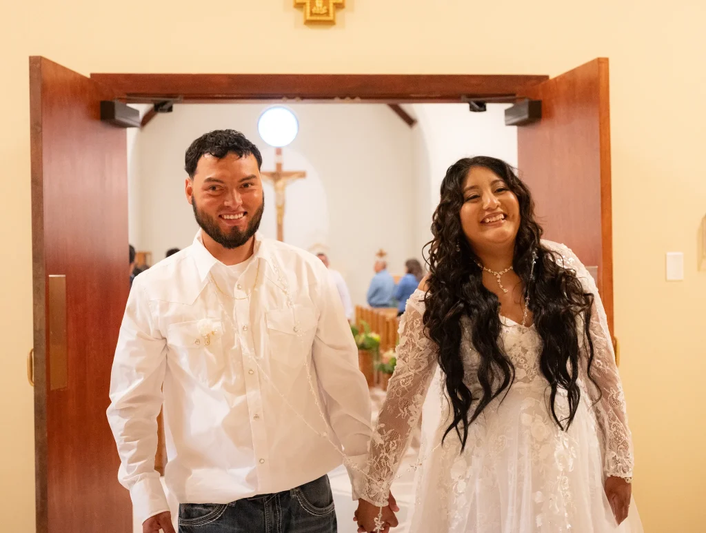 A photo of a happy couple walking down the aisle on their wedding day