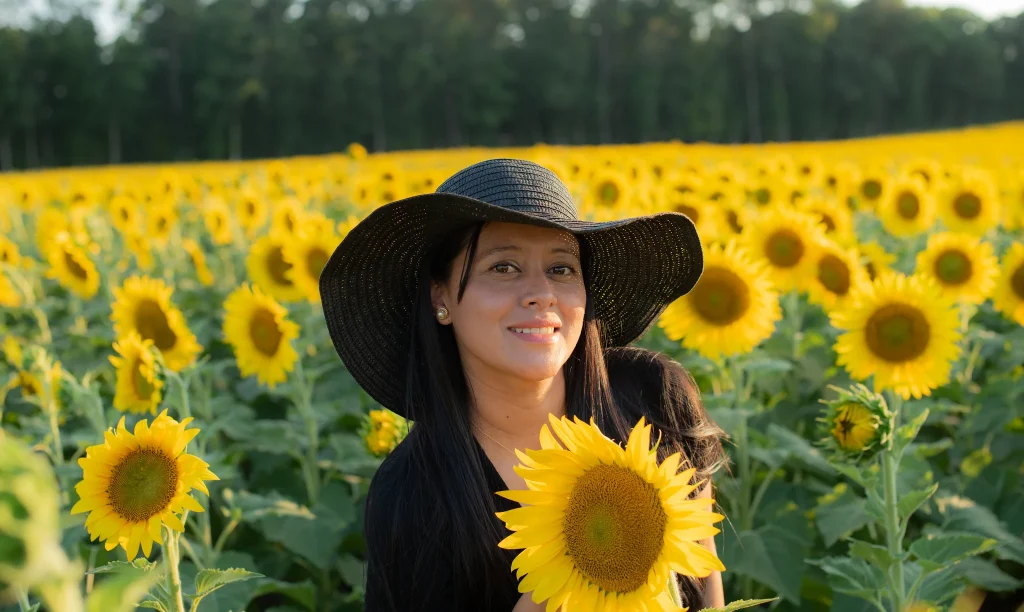 bio photo of a photographer surrounded by sunflowers